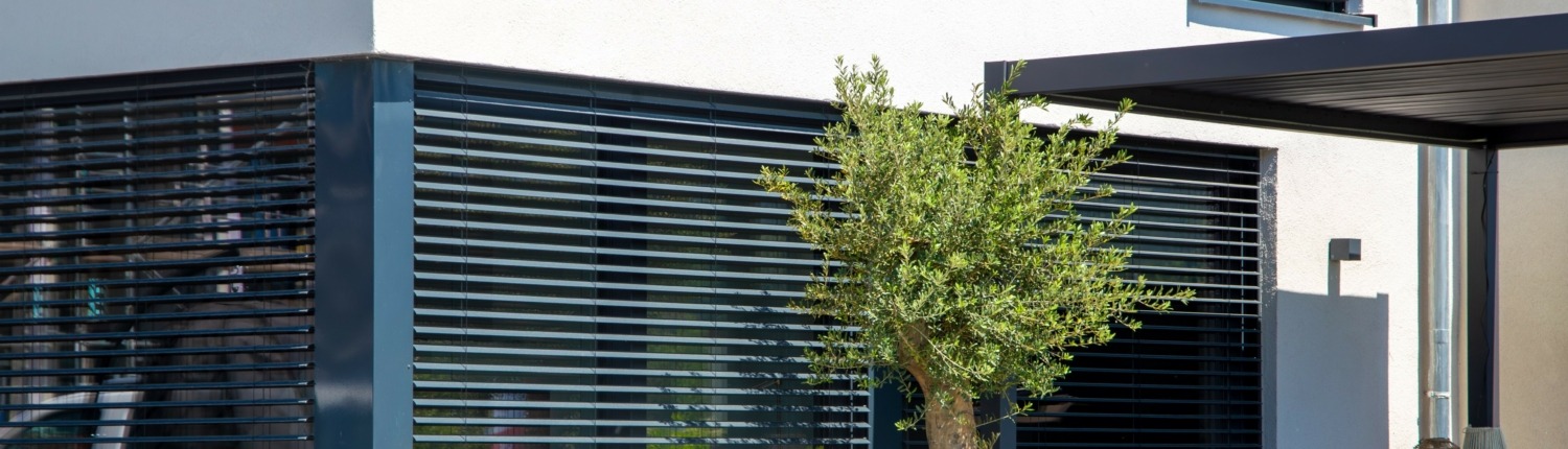 Modern blinds on a sliding window with access to the garden terrace
